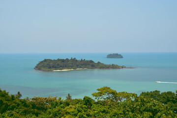 Obraz premium Beautiful landscapes island on the blue sea and speed boat drive through the island. Snap shot on the other side of the island.