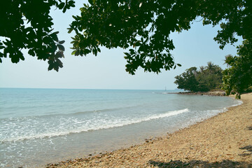 View of sea and some leaves of tree on the corner picture. Snap shot on the beach side.