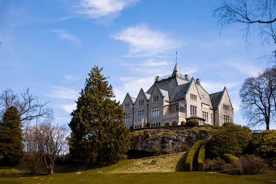 Gamlehaugen castle in Bergen, Norway behind the park. Warm spring color