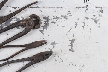 Old rusty construction tools on a gray iron background close-up