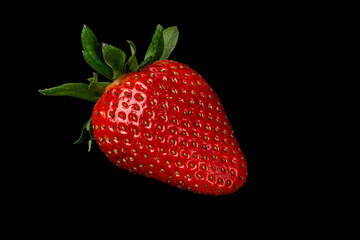 ripe strawberries on a black background close up