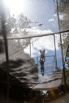 Creative Silhouette Of Two Trapeze Artists Performing Outside