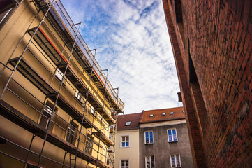 Closeup of a row of colorful buildings with restaurants in the old city square
