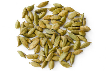 Heap of dry green cardamons on a white background