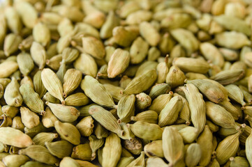 Closeup of a heap of dry green cardamons