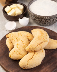 Chipas, typical south american cheese bun over wooden table with ingredients