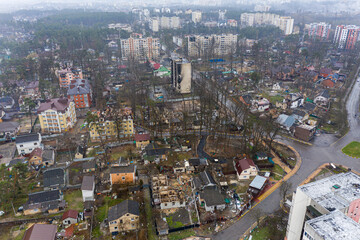 Fototapeta na wymiar The aerial view of the destroyed and burnt buildings. The buildings were destroyed by russian rockets and mines. The Ukrainian cities after the russian occupation.