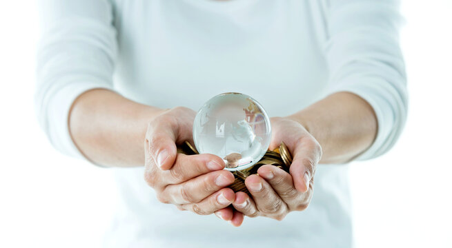 Crystal globe and coins in hands