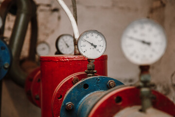 Manometers on pipes in the basement, heating system of an apartment building