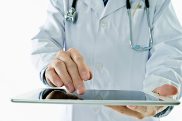 Doctor working on digital tablet against white background