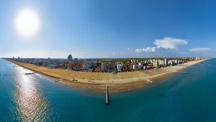 Jesolo in a aerialial panoramic view on blue sea - golden beach and sea with  back city