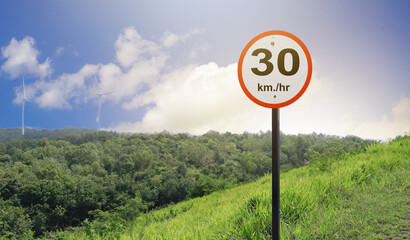 A warning sign prohibiting speeding over 30km per hour on the roadside on a mountain slope to reduce the danger of using a vehicle on the road.