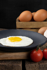 Delicious egg on black plate.