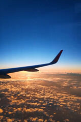 Vertical shot of an airplane wing seen through a window