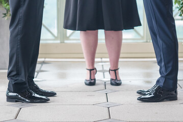 Grooms standing with the officiant during their marriage ceremony