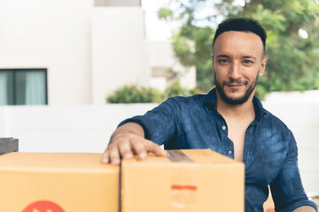 Caucasian delivery man using a forklift to deliver parcels in boxes. Delivery concept.