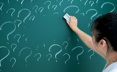 Woman erasing question mark on chalkboard