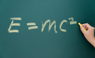 Einstein equation emc2 handwritten chalk on blackboard