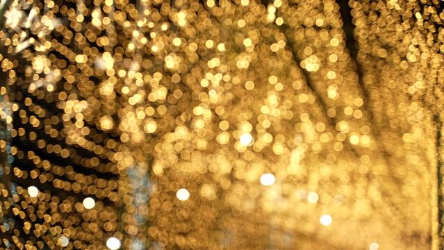 abstract blurry background of bright light bokeh in yellow gold color at night, xmas festive decorate shine effect for Christmas night
