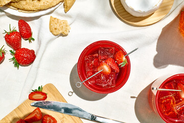 Cozy spring or summer breakfast or brunch outside on the table. Strawberry mocktail, camembert cheese, flat crispbread on linen tablecloth. Healthy snack. Picnic.