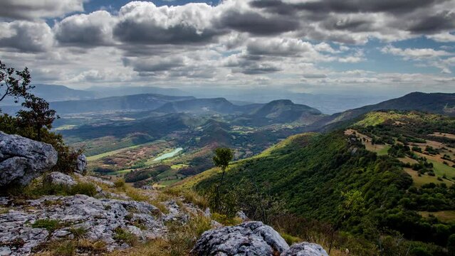A dramatic timelapse of the clouds and moutains in Innimond, Ain, Rh&ocirc;ne-Alpes, France. Shot in spring from the top of a hill, great light movement, Deep and layered landscape shot.