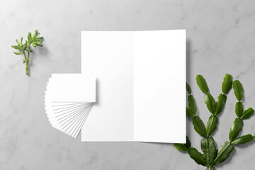 Clean minimal business card mockup on paper card with green leaves