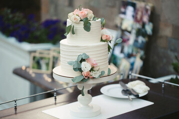 Beautiful wedding cake for the newlyweds at the wedding. A birthday cake at a banquet.