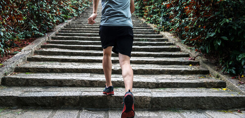 Low section of runner athlete running on staircase