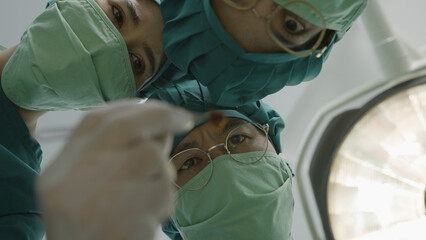 Team of professional doctors operating surgery is picking up the cancer cells in hospital operating...