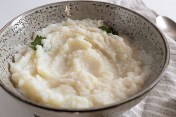 mashed cauliflower puree in bowl. paleo diet. closeup view, selective focus