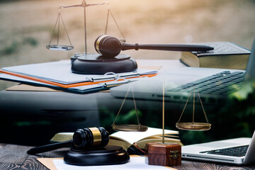 Judge gavel with Justice lawyers having team meeting at law firm in background. Concepts of law.