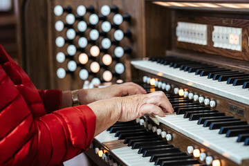 Elder female playing an organ instrument at a church