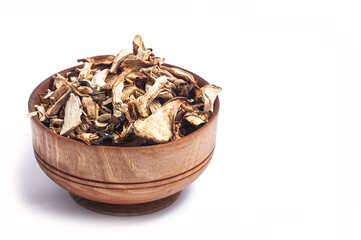 dried white mushroom slices in wooden bowl on white background.