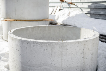 Close-up of the reinforced concrete wall ring of the well stored in the warehouse of the precast concrete factory.