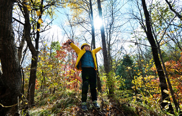 Funny happy child in autumn forest