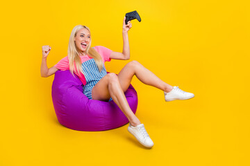Full body profile portrait of excited delighted girl raise fist celebrate triumph isolated on...