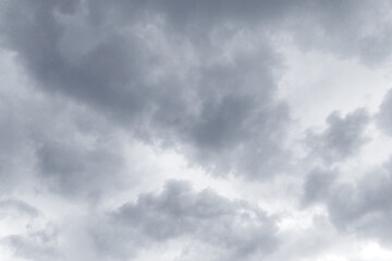 Gray clouds in the dark sky. Cloudy clouds on a rainy day. Strong cloud cover, bad weather. A storm warning. Beautiful background. Stormy summer sky. Heaven and infinity