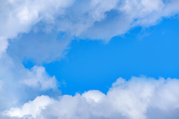 Light cloudy, good weather. Curly clouds on a sunny day. Summer sky. Beautiful bright blue background. Heaven and infinity. White clouds in the blue sky