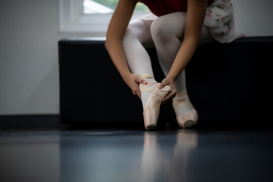 Close-up of a professional female ballerina wearing ballet shoes to practice choreography.