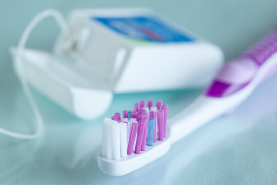 closeup of toothbrush and dental floss