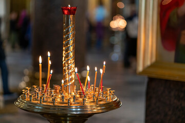 Church atmosphere, candles and bokeh yellow lights. Religious holiday.