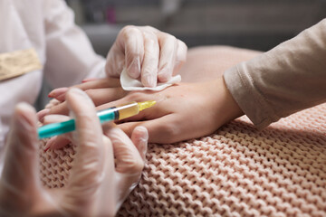 Doctor doing stem cell therapy on a patient's elbow after the injury. Treating knee pain with...