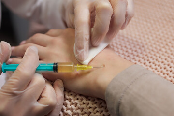 Doctor doing stem cell therapy on a patient's elbow after the injury. Treating knee pain with...