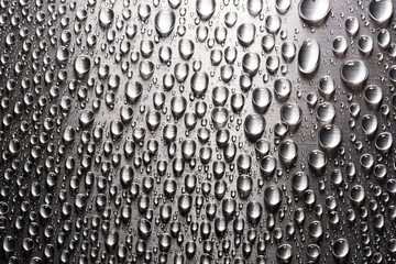 Abstract background with drops of water on metal flat surface