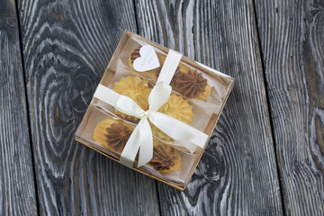 Homemade eclairs with cream. They lie on a plate. Custard pastries with cream. In a gift box. Close-up.