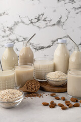 Bottles and glasses of assorted milk alternatives, lactose free, vegetable