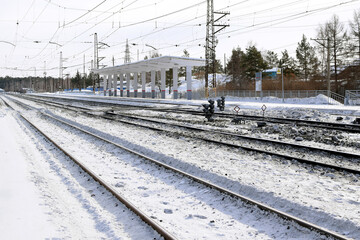 Fototapeta na wymiar Empty passenger platform, winter station.