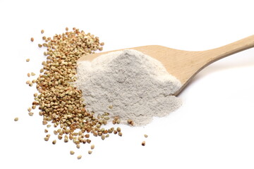 Buckwheat flour and grain in wooden spoon isolated on white  