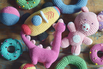 Crochet toy for child on wooden background. Handmade crafts. DIY concept. Small business. Income from hobby