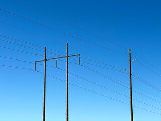 Power lines against a blue sky. Concept of hydro electric, energy, the grid.
